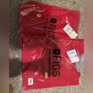 Figs pop red scrubs with gold details